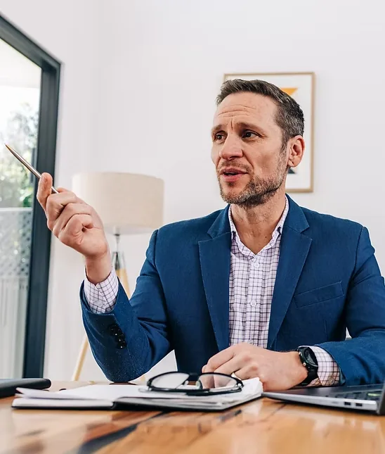 Alex McConville, founder of AM Coaching, at his desk